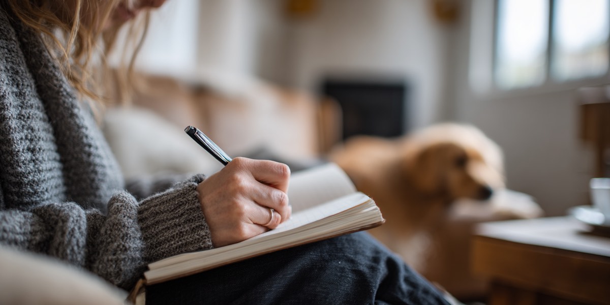 woman writing in a training journal